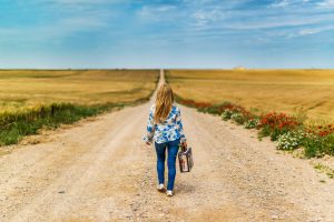 woman walking alone long road